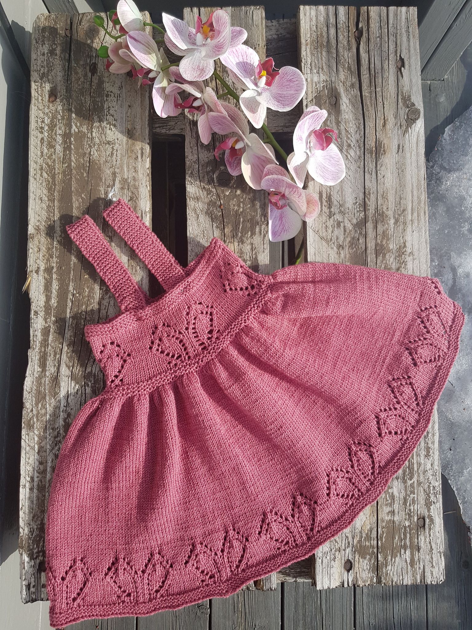 Nagga Lille hjerte kjole Kjolen er strikket slik at den "vokser"med barnet ved at man kan tilpasse seler etterhvert og med stor vidde i skjørtet.
Det er noen farger som er utgått, blant annet fargen på hovedbildet "på brygga". Sjekk hvilken farge du vil ha, og dersom du ønsker annen farge, trykk på den grønne "+" knappen så ser du hva som er tilgjengelig. 
